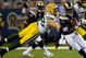 ST. LOUIS, MO - SEPTEMBER 27: Clay Matthews #52 of the Green Bay Packers tackles Keenan Burton #14 of the St. Louis Rams at the Edward Jones Dome on September 27, 2009 in St. Louis, Missouri.  The Packers beat the Rams 36-17.  (Photo by Dilip Vishwanat/Getty Images)