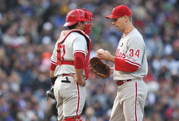 DENVER - OCTOBER 11:  Cliff Lee #34 of the Philadelphia Phillies talks to catcher Carlos Ruiz #51 on the mound against the Colorado Rockies in Game Four of the NLDS during the 2009 MLB Playoffs at Coors Field on October 12, 2009 in Denver, Colorado. (Photo by Jed Jacobsohn/Getty Images)