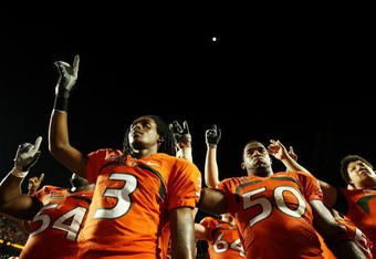 FORT LAUDERDALE, FL - OCTOBER 03: Wide receiver Travis Benjamin #3 and linebacker Darryl Sharpton #50 of the Miami Hurricanes celebrate after defeating the Oklahoma Sooners at Land Shark Stadium on October 3, 2009 in Fort Lauderdale, Florida. Miami defeated Oklahoma 21-20. (Photo by Doug Benc/Getty Images)