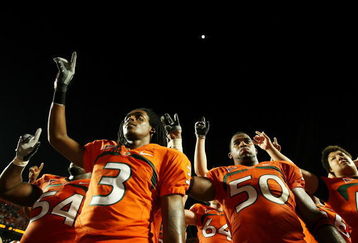 FORT LAUDERDALE, FL - OCTOBER 03: Wide receiver Travis Benjamin #3 and linebacker Darryl Sharpton #50 of the Miami Hurricanes celebrate after defeating the Oklahoma Sooners at Land Shark Stadium on October 3, 2009 in Fort Lauderdale, Florida. Miami defeated Oklahoma 21-20. (Photo by Doug Benc/Getty Images)