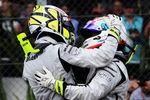 SAO PAULO, BRAZIL - OCTOBER 18:  Jenson Button (L) of Great Britain and Brawn GP is congratulated by team mate Rubens Barrichello (R) of Brazil and Brawn GP as he celebrates in parc ferme after clinching the F1 World Drivers Championship during the Brazilian Formula One Grand Prix at the Interlagos Circuit on October 18, 2009 in Sao Paulo, Brazil.  (Photo by Clive Mason/Getty Images)