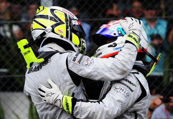 SAO PAULO, BRAZIL - OCTOBER 18:  Jenson Button (L) of Great Britain and Brawn GP is congratulated by team mate Rubens Barrichello (R) of Brazil and Brawn GP as he celebrates in parc ferme after clinching the F1 World Drivers Championship during the Brazilian Formula One Grand Prix at the Interlagos Circuit on October 18, 2009 in Sao Paulo, Brazil.  (Photo by Clive Mason/Getty Images)
