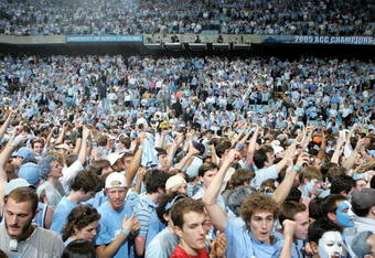CHAPEL HILL, NC - MARCH 6:  Fans of the North Carolina Tar Heels celebrate winning the ACC Regular Season Championship on the court after their game against the Duke Blue Devils on March 6, 2005 at the Dean E. Smith Center in Chapel Hill, North Carolina. The Tar Heels defeated the Blue Devils 75-73.  (Photo by Streeter Lecka/Getty Images)