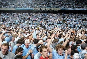 CHAPEL HILL, NC - MARCH 6:  Fans of the North Carolina Tar Heels celebrate winning the ACC Regular Season Championship on the court after their game against the Duke Blue Devils on March 6, 2005 at the Dean E. Smith Center in Chapel Hill, North Carolina. The Tar Heels defeated the Blue Devils 75-73.  (Photo by Streeter Lecka/Getty Images)
