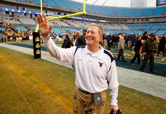 CHARLOTTE, NC - DECEMBER 27:  Head coach Bill Stewart of the West Virginia Mountaineers celebrates after a 31-30 victory over the North Carolina Tar Heels after the Meineke Car Care Bowl on December 27, 2008 at Bank of America Stadium in Charlotte, North Carolina.  (Photo by Streeter Lecka/Getty Images)