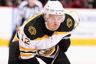 GLENDALE, AZ - OCTOBER 17:  Chuck Kobasew #12 of the Boston Bruins leans in during a face off in the NHL game against the Phoenix Coyotes at Jobing.com Arena on October 17, 2009 in Glendale, Arizona. The Coyotes defeated the Bruins 4-1.  (Photo by Christian Petersen/Getty Images)