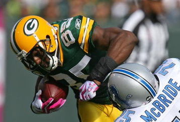 GREEN BAY, WI - OCTOBER 18: Greg Jennings #85 of the Green Bay Packers tries to break away from Turk McBride #75 of the Detroit Lions at Lambeau Field on October 18, 2009 in Green Bay, Wisconsin. The Packers defeated the Lions 26-0. (Photo by Jonathan Daniel/Getty Images)