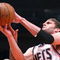 NEW YORK - MARCH 18: Brook Lopez #11 of the New Jersey Nets shoots over Wilson Chandler #21 of the New York Knicks at Madison Square Garden March 18, 2009 in New York City. NOTE TO USER: User expressly acknowledges and agrees that, by downloading and/or using this Photograph, User is consenting to the terms and conditions of the Getty Images License Agreement. (Photo by Chris McGrath/Getty Images)