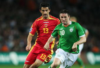 DUBLIN, IRELAND - OCTOBER 14: Robbie Keane of the Republic of Ireland avoids Mitar Novakovic of Montenegro during the FIFA 2010 World Cup European Qualifying match between the Republic of Ireland and Montenegro at Croke Park on October 14, 2009 in Dublin, Ireland.  (Photo by Bryn Lennon/Getty Images)
