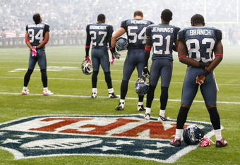 SEATTLE, WA - OCTOBER 18:  Members of the Seattle Seahawks listen to the national anthem prior to the game against the Arizona Cardinals at Qwest Field on October 18, 2009 in Seattle, Washington.  (Photo by Jonathan Ferrey/Getty Images)