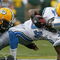 GREEN BAY, WI - OCTOBER 18:  Kevin Smith #34 of the Detroit Lions is tackled by Ryan Pickett #79 and A.J. Hawk #50 of the Green Bay Packers at Lambeau Field on October 18, 2009 in Green Bay, Wisconsin. The Packers defeated the Lions 26-0. (Photo by Jonathan Daniel/Getty Images)
