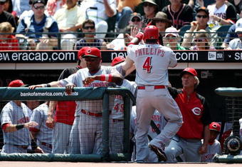 SAN FRANCISCO - AUGUST 9:  Brandon Phillips #4 of the Cincinnati Reds celebrates with his teammates in the dugout after he hit a solo home run in the top of the first inning against the San Francisco Giants at AT&T Park  on August 9, 2009 in San Francisco, California.  (Photo by Jed Jacobsohn/Getty Images)