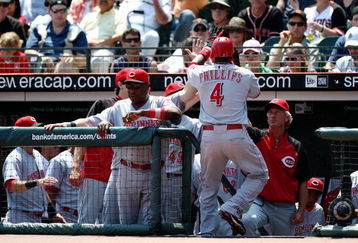 SAN FRANCISCO - AUGUST 9:  Brandon Phillips #4 of the Cincinnati Reds celebrates with his teammates in the dugout after he hit a solo home run in the top of the first inning against the San Francisco Giants at AT&T Park  on August 9, 2009 in San Francisco, California.  (Photo by Jed Jacobsohn/Getty Images)