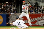 NEW YORK - OCTOBER 17:  Erick Aybar #2 of the Los Angeles Angels of Anaheim turns a double play to put out Brett Gardner #11 of the New York Yankees in Game Two of the ALCS during the 2009 MLB Playoffs at Yankee Stadium on October 17, 2009 in the Bronx borough of New York City.  (Photo by Al Bello/Getty Images)
