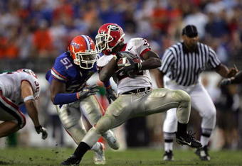 JACKSONVILLE, FL - OCTOBER 27:  Tailback Knowshon Moreno #24 of the Georgia Bulldogs runs the ball against Brandon Spikes #51 of the Florida Gators at Jacksonville Municipal Stadium on October 27, 2007 in Jacksonville, Florida.  (Photo by Ronald Martinez/Getty Images)