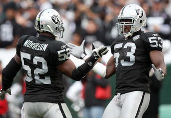 OAKLAND, CA - OCTOBER 18:  Thomas Howard #53 and Kirk Morrison #52 of the Oakland Raiders celebrate after a play against the Philadelphia Eagles during an NFL game at the Oakland-Alameda County Coliseum on October 18, 2009 in Oakland, California.  (Photo by Jed Jacobsohn/Getty Images)