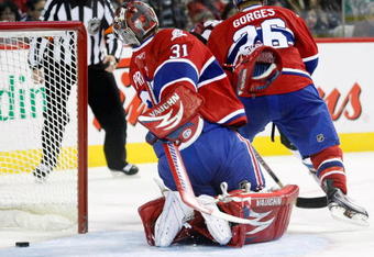 MONTREAL- OCTOBER 15:  Carey Price #31 of the Montreal Canadiens looks behind himself to find the puck on a gola by Kyle Cumiskey #10 of the Colorado Avalanche during the NHL game on October 15, 2009 at the Bell Centre in Montreal, Quebec, Canada.  The Avalanche defeated the Canadiens 3-2.  (Photo by Richard Wolowicz/Getty Images)
