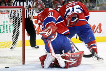 MONTREAL- OCTOBER 15:  Carey Price #31 of the Montreal Canadiens looks behind himself to find the puck on a gola by Kyle Cumiskey #10 of the Colorado Avalanche during the NHL game on October 15, 2009 at the Bell Centre in Montreal, Quebec, Canada.  The Avalanche defeated the Canadiens 3-2.  (Photo by Richard Wolowicz/Getty Images)