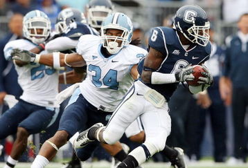 EAST HARTFORD, CT - SEPTEMBER 12:  Jasper Howard #6 of the Connecticut Huskies carries the ball as Johnny White #34 of the North Carolinia Tar Heels tries to make the tackle on September 12, 2009 at Rentschler Field in East Hartford, Connecticut.  (Photo by Elsa/Getty Images)