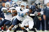 EAST HARTFORD, CT - SEPTEMBER 12:  Jasper Howard #6 of the Connecticut Huskies carries the ball as Johnny White #34 of the North Carolinia Tar Heels tries to make the tackle on September 12, 2009 at Rentschler Field in East Hartford, Connecticut.  (Photo by Elsa/Getty Images)