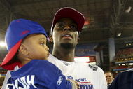 GLENDALE, AZ - FEBRUARY 03:  Plaxico Burress #17 of the New York Giants celebrates with his son Elijah Burress after the Giants defeated the New England Patriots 17-14 during Super Bowl XLII on February 3, 2008 at the University of Phoenix Stadium in Glendale, Arizona.  (Photo by Donald Miralle/Getty Images)