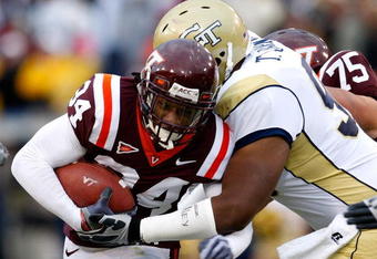 ATLANTA - OCTOBER 17:  Ryan Williams #34 of the Virginia Tech Hokies is tackled by T.J. Barnes #90 of the Georgia Tech Yellow Jackets at Bobby Dodd Stadium on October 17, 2009 in Atlanta, Georgia.  (Photo by Kevin C. Cox/Getty Images)