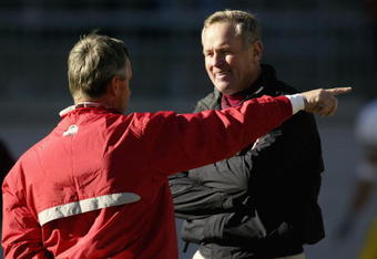 COLUMBUS, OH - NOVEMBER 02:  Head Coach Glen Mason of the Minnesota Golden Gophers talks with Head Coach Jim Tressel of the Ohio State Buckeyes during the game at Ohio Stadium on November 2, 2002 in Columbus, Ohio.  Ohio State won 34-7.  (Photo by Tom Pidgeon/Getty Images)