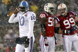 FOXBORO - OCTOBER 18:  Vince Young #10 of the Tennessee Titans leaves the field as Pierre Woods #58 and Mike Wright #99 of the New England Patriots converse at Gillette Stadium on October 18, 2009 in Foxboro, Massachusetts. The Patriots won 59-0. (Photo by Jim Rogash/Getty Images)