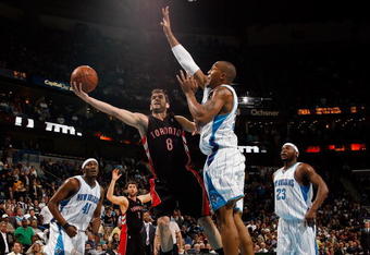 NEW ORLEANS - FEBRUARY 06:  Jose Calderon #8 of the Toronto Raptors makes a shot around David West #30 of the New Orleans Hornets on February 6, 2009 in New Orleans, Louisiana. The Hornets defeated the Raptors 101-92.   NOTE TO USER: User expressly acknowledges and agrees that, by downloading and/or using this Photograph, user is consenting to the terms and conditions of the Getty Images License Agreement.  (Photo by Chris Graythen/Getty Images)