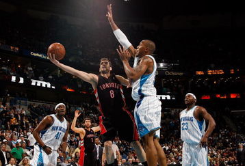 NEW ORLEANS - FEBRUARY 06:  Jose Calderon #8 of the Toronto Raptors makes a shot around David West #30 of the New Orleans Hornets on February 6, 2009 in New Orleans, Louisiana. The Hornets defeated the Raptors 101-92.   NOTE TO USER: User expressly acknowledges and agrees that, by downloading and/or using this Photograph, user is consenting to the terms and conditions of the Getty Images License Agreement.  (Photo by Chris Graythen/Getty Images)