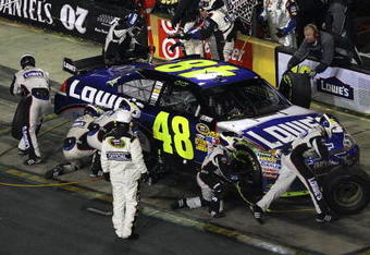 CONCORD, NC - OCTOBER 17:  Jimmie Johnson, driver of the #48 Lowe's Chevrolet, makes a pit stop during the NASCAR Sprint Cup Series NASCAR Banking 500 at Lowe's Motor Speedway on October 17, 2009 in Concord, North Carolina.  (Photo by Streeter Lecka/Getty Images)