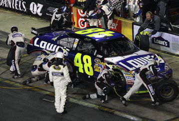 CONCORD, NC - OCTOBER 17:  Jimmie Johnson, driver of the #48 Lowe's Chevrolet, makes a pit stop during the NASCAR Sprint Cup Series NASCAR Banking 500 at Lowe's Motor Speedway on October 17, 2009 in Concord, North Carolina.  (Photo by Streeter Lecka/Getty Images)