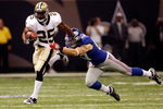 NEW ORLEANS - OCTOBER 18:  Reggie Bush #25 of the New Orleans Saints escapes a tackle by Chase Blackburn #57 of the New York Giants at the Louisiana Superdome on October 18, 2009 in New Orleans, Louisiana.  (Photo by Chris Graythen/Getty Images)