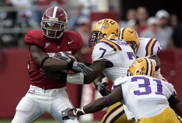 TUSCALOOSA, AL - NOVEMBER 12:  Kenneth Darby #34 of the University of Alabama is tackled by center Ali Highsmith #7 of Louisiana State University on November 12, 2005 at at Bryant-Denny Stadium in Tuscaloosa, Alabama.  (Photo by Chris Graythen/Getty Images) 
