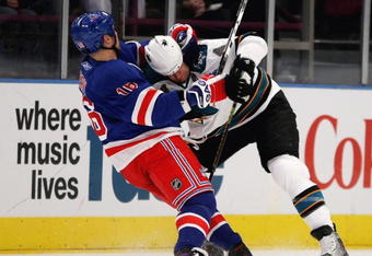 NEW YORK - OCTOBER 19: Rob Blake #4 of the San Jose Sharks is held by Sean Avery #16 of the New York Rangers at Madison Square Garden on October 19, 2009 in New York City.  (Photo by Bruce Bennett/Getty Images)