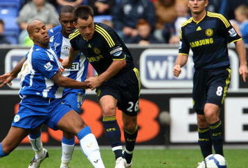 WIGAN, ENGLAND - SEPTEMBER 26: John Terry of Chelsea gets tackled by Marlon King of Wigan Athletic during the Barclays Premier League match between Wigan Athletic and Chelseaat JJB Stadium on September 26, 2009 in Wigan, England.  (Photo by Phil Cole/Getty Images)