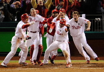 PHILADELPHIA - OCTOBER 19:  Carlos Ruiz #51 (C) of the Philadelphia Phillies celebrates with his teammates after he scored the winning run on a walkoff 2-run double by Jimmy Rollins #11 against the Los Angeles Dodgers in Game Four of the NLCS during the 2009 MLB Playoffs at Citizens Bank Park on October 19, 2009 in Philadelphia, Pennsylvania. The Phillies won 5-4.  (Photo by Jeff Zelevansky/Getty Images)