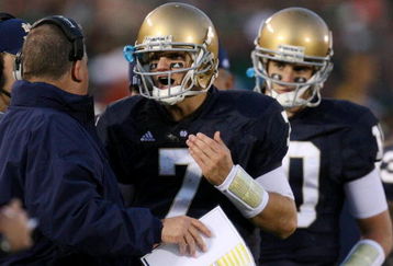 SOUTH BEND, IN - OCTOBER 17: Head coach Charlie Weis of the Notre Dame Fighting Irish speaks to quarterback Jimmy Clausen #7 during the fourth quarter against the USC Trojans at Notre Dame Stadium on October 17, 2009 in South Bend, Indiana. USC won the game 34-27. (Photo by Jonathan Daniel/Getty Images)