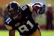 TAMPA, FL - JANUARY 01: Tony Moeaki #81 of the Iowa Hawkeyes runs upfield as he fights off the tackle of Chris Culliver #17 of the South Carolina Gamecocks during the Outback Bowl on January 1, 2009 at Raymond James Stadium in Tampa, Florida. (Photo by Scott Halleran/Getty Images)