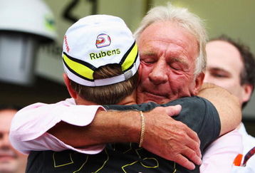 SAO PAULO, BRAZIL - OCTOBER 18:  Rubens Barrichello (L) of Brazil and Brawn GP is embraced by Jenson Buttons father John Button (R) after his son clinched the F1 World Drivers Championship during the Brazilian Formula One Grand Prix at the Interlagos Circuit on October 18, 2009 in Sao Paulo, Brazil.  (Photo by Mark Thompson/Getty Images)