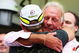 SAO PAULO, BRAZIL - OCTOBER 18: Rubens Barrichello (L) of Brazil and Brawn GP is embraced by Jenson Buttons father John Button (R) after his son clinched the F1 World Drivers Championship during the Brazilian Formula One Grand Prix at the Interlagos Circuit on October 18, 2009 in Sao Paulo, Brazil. (Photo by Mark Thompson/Getty Images)
