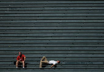 DENVER - SEPTEMBER 18:  Two fans in the vacant centerfield bleachers bask in the warm sun on a late summer afternoon as the Colorado Rockies host the Los Angeles Dodgers at Coors Field on September 18, 2007 in Denver, Colorado. The Rockies defeated the Dodgers 3-1 in the first game of a double header.  (Photo by Doug Pensinger/Getty Images)