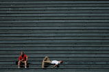 DENVER - SEPTEMBER 18:  Two fans in the vacant centerfield bleachers bask in the warm sun on a late summer afternoon as the Colorado Rockies host the Los Angeles Dodgers at Coors Field on September 18, 2007 in Denver, Colorado. The Rockies defeated the Dodgers 3-1 in the first game of a double header.  (Photo by Doug Pensinger/Getty Images)