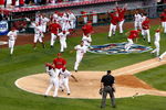 ANAHEIM, CA - OCTOBER 19:  Howie Kendrick #47 (Bottom) of the Los Angeles Angels of Anaheim celebrates with teammate Erick Aybar #2 after sliding home off of Jeff Mathis #5 (Not Shown) walk off double in 11th inning in Game Three of the ALCS during the 2009 MLB Playoffs at Angel Stadium on October 19, 2009 in Anaheim, California.  (Photo by Jeff Gross/Getty Images)