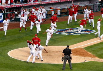 ANAHEIM, CA - OCTOBER 19:  Howie Kendrick #47 (Bottom) of the Los Angeles Angels of Anaheim celebrates with teammate Erick Aybar #2 after sliding home off of Jeff Mathis #5 (Not Shown) walk off double in 11th inning in Game Three of the ALCS during the 2009 MLB Playoffs at Angel Stadium on October 19, 2009 in Anaheim, California.  (Photo by Jeff Gross/Getty Images)