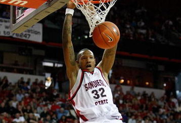 LAS VEGAS - MARCH 12:  Billy White #32 of the San Diego State Aztecs dunks next to Mareceo Rutledge #3 of the UNLV Rebels during a quarterfinal game of the Conoco Mountain West Conference Basketball Championships at the Thomas & Mack Center March 12, 2009 in Las Vegas, Nevada.  (Photo by Ethan Miller/Getty Images)