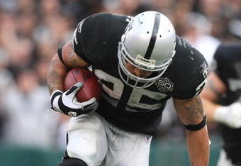 OAKLAND, CA - OCTOBER 18:  Justin Fargas #25 of the Oakland Raiders runs against Sheldon Brown #24 of the Philadelphia Eagles during an NFL game at the Oakland-Alameda County Coliseum on October 18, 2009 in Oakland, California.  (Photo by Jed Jacobsohn/Getty Images)