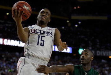 DETROIT - APRIL 04:  Kemba Walker #15 of the Connecticut Huskies goes up for a shot over Travis Walton #5 of the Michigan State Spartans during the National Semifinal game of the NCAA Division I Men's Basketball Championship at Ford Field on April 4, 2009 in Detroit, Michigan.  (Photo by Andy Lyons/Getty Images)