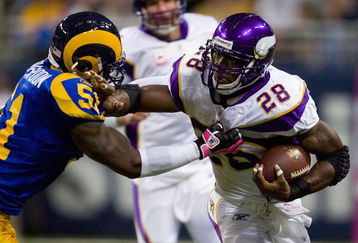 ST. LOUIS, MO - OCTOBER 11: Adrian Peterson #28 of the Minnesota Vikings looks to get past Will Witherspoon #51 of the St. Louis Rams at the Edward Jones Dome on October 11, 2009 in St. Louis, Missouri.  (Photo by Dilip Vishwanat/Getty Images)