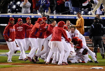 PHILADELPHIA - OCTOBER 19:  The Philadelphia Phillies pile on Jimmy Rollins #11 after Rollins hit a game-winning walkoff 2-run double in the bottom of the ninth inning to win 5-4 against the Los Angeles Dodgers in Game Four of the NLCS during the 2009 MLB Playoffs at Citizens Bank Park on October 19, 2009 in Philadelphia, Pennsylvania.  (Photo by Jeff Zelevansky/Getty Images)